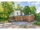 Back exterior view of a charming two-story home with a brick facade, deck, and yard at 3209 Marie Dr, Raleigh, NC 27604