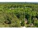 Aerial view of a home surrounded by lush greenery and mature trees in a well-established neighborhood at 3425 Donnigale Ave, Durham, NC 27705