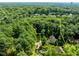 Aerial view of a wooded lot with approximate property lines and a house nestled among mature trees at 3425 Donnigale Ave, Durham, NC 27705