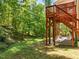View of backyard, patio and stone fireplace from deck; wooded view at 3425 Donnigale Ave, Durham, NC 27705