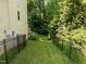 Fenced backyard with mature shade trees and access to a patio at 3425 Donnigale Ave, Durham, NC 27705