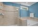 Bathroom featuring glass-enclosed shower and soaking tub with tile surround at 3425 Donnigale Ave, Durham, NC 27705