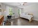 Well-lit bedroom with hardwood floors, a desk, and a comfortable seating area at 3425 Donnigale Ave, Durham, NC 27705