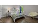 Inviting bedroom with a cozy bed, side tables with lamps, and hardwood floors at 3425 Donnigale Ave, Durham, NC 27705