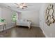 Cozy bedroom with wood floors, a ceiling fan, and a window with a view at 3425 Donnigale Ave, Durham, NC 27705