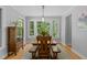 Inviting dining room with large windows offering a scenic view, complemented by a classic wooden table set at 3425 Donnigale Ave, Durham, NC 27705