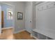 Entryway featuring wood floors, coat hooks, and a doorway leading to a blue-walled room at 3425 Donnigale Ave, Durham, NC 27705