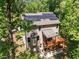 Aerial view of home with solar panels, rear deck, and mature trees at 3425 Donnigale Ave, Durham, NC 27705
