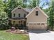 Charming two-story home with a welcoming front porch, attached two-car garage, and well-maintained landscaping at 3425 Donnigale Ave, Durham, NC 27705