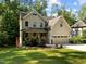 Two-story home featuring a two-car garage and landscaped front yard with mature trees in a desirable location at 3425 Donnigale Ave, Durham, NC 27705