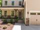 Inviting front entrance with a covered porch, stone accents, and a beautifully landscaped yard, creating curb appeal at 3425 Donnigale Ave, Durham, NC 27705