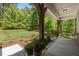 Relaxing front porch with views of a lush green lawn and mature trees, ideal for enjoying the outdoors at 3425 Donnigale Ave, Durham, NC 27705