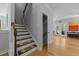 Bright hallway with hardwood floors, leading to a staircase and an inviting living area with french doors at 3425 Donnigale Ave, Durham, NC 27705