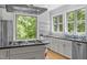 Kitchen features a large center island with a cooktop, stainless steel appliances, and ample natural light at 3425 Donnigale Ave, Durham, NC 27705
