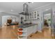 Open kitchen with island cooktop, wood floors, and seamless transition to dining and living spaces at 3425 Donnigale Ave, Durham, NC 27705