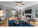 Spacious living room featuring fireplace, wood floors, comfortable seating, and open archway to kitchen at 3425 Donnigale Ave, Durham, NC 27705