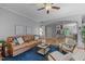 Bright living room with wood floors, leather sofa, two chairs, and an archway to another room at 3425 Donnigale Ave, Durham, NC 27705