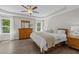 Well-lit main bedroom with wood flooring, white walls, and a ceiling fan at 3425 Donnigale Ave, Durham, NC 27705