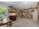 Office with wrap-around built-in bookshelves, large desk, and window overlooking trees at 3425 Donnigale Ave, Durham, NC 27705