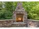 Close-up of outdoor stone fireplace with tools and a stone surround at 3425 Donnigale Ave, Durham, NC 27705
