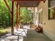 Covered patio with brick fireplace and steps up to home entrance at 3425 Donnigale Ave, Durham, NC 27705