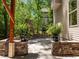 View of patio's stone pillars, chimney, and landscaped backyard at 3425 Donnigale Ave, Durham, NC 27705