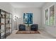 Cozy sitting room features two armchairs, a unique blue rug and a large window for natural light at 3425 Donnigale Ave, Durham, NC 27705
