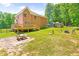 Spacious backyard showcasing a deck, playset, and grassy area, ideal for outdoor activities and gatherings at 3436 Candlebrook Ct, Mebane, NC 27302