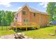 Backyard featuring a wooden deck, and lush greenery, perfect for relaxation and entertainment at 3436 Candlebrook Ct, Mebane, NC 27302