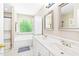 Bright bathroom with dual sinks and a jacuzzi tub at 3436 Candlebrook Ct, Mebane, NC 27302