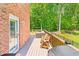 Cozy deck with an outdoor lounge and grill, perfect for relaxing and enjoying the backyard view at 3436 Candlebrook Ct, Mebane, NC 27302