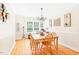 Bright dining room with hardwood floors and a wooden table at 3436 Candlebrook Ct, Mebane, NC 27302