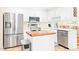 Efficient kitchen with white cabinetry, stainless steel appliances, and a butcher block island at 3436 Candlebrook Ct, Mebane, NC 27302