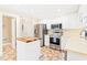 Bright kitchen featuring white cabinets, stainless steel appliances, and a tile backsplash at 3436 Candlebrook Ct, Mebane, NC 27302