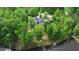 A beautiful aerial view of a home nestled in a lush forest with private lake access at 35 Fire Tower Dr, Rougemont, NC 27572
