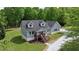 Aerial view of a gray home with a dark roof and a long driveway at 35 Fire Tower Dr, Rougemont, NC 27572