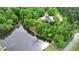 Aerial shot of a home on a treed lot with waterfront and a dock on the lake at 35 Fire Tower Dr, Rougemont, NC 27572