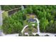 Serene aerial view of a home surrounded by lush greenery and a tranquil pond at 35 Fire Tower Dr, Rougemont, NC 27572