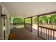 Back porch has ceiling, welcome mat, wood paneling, and a view of the lake at 35 Fire Tower Dr, Rougemont, NC 27572