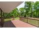 The wooden back porch overlooks the beautiful outdoor scenery at 35 Fire Tower Dr, Rougemont, NC 27572