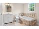 Bright bathroom with tile surround tub, tile floor, vanity, toilet, and natural light at 35 Fire Tower Dr, Rougemont, NC 27572