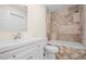 Recently remodeled bathroom with attractive tile surround, white vanity, and modern fixtures, and a neutral color palette at 35 Fire Tower Dr, Rougemont, NC 27572