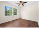 Bright bedroom with hardwood floors, ceiling fan, and a large window offering great natural light at 35 Fire Tower Dr, Rougemont, NC 27572