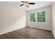 Bright bedroom featuring wood-look floors, crisp white trim, a ceiling fan, and large windows with a lovely treed view at 35 Fire Tower Dr, Rougemont, NC 27572