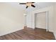 Clean, simple bedroom featuring wood-look floors, crisp white trim, a ceiling fan and ample closet space at 35 Fire Tower Dr, Rougemont, NC 27572