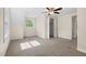 Bedroom featuring neutral carpet and trim, a ceiling fan, and a double window at 35 Fire Tower Dr, Rougemont, NC 27572