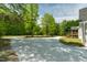Long driveway leading to a gray home, surrounded by green trees at 35 Fire Tower Dr, Rougemont, NC 27572