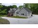 Gray home featuring a covered porch and well-maintained landscaping at 35 Fire Tower Dr, Rougemont, NC 27572