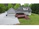 A full backyard view of the home, with a spacious deck that's perfect for entertaining at 35 Fire Tower Dr, Rougemont, NC 27572