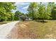 View of a charming gray home nestled within a lush, green landscape at 35 Fire Tower Dr, Rougemont, NC 27572